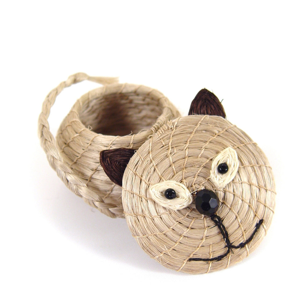 Woven cat-shaped basket with a face design on a white background