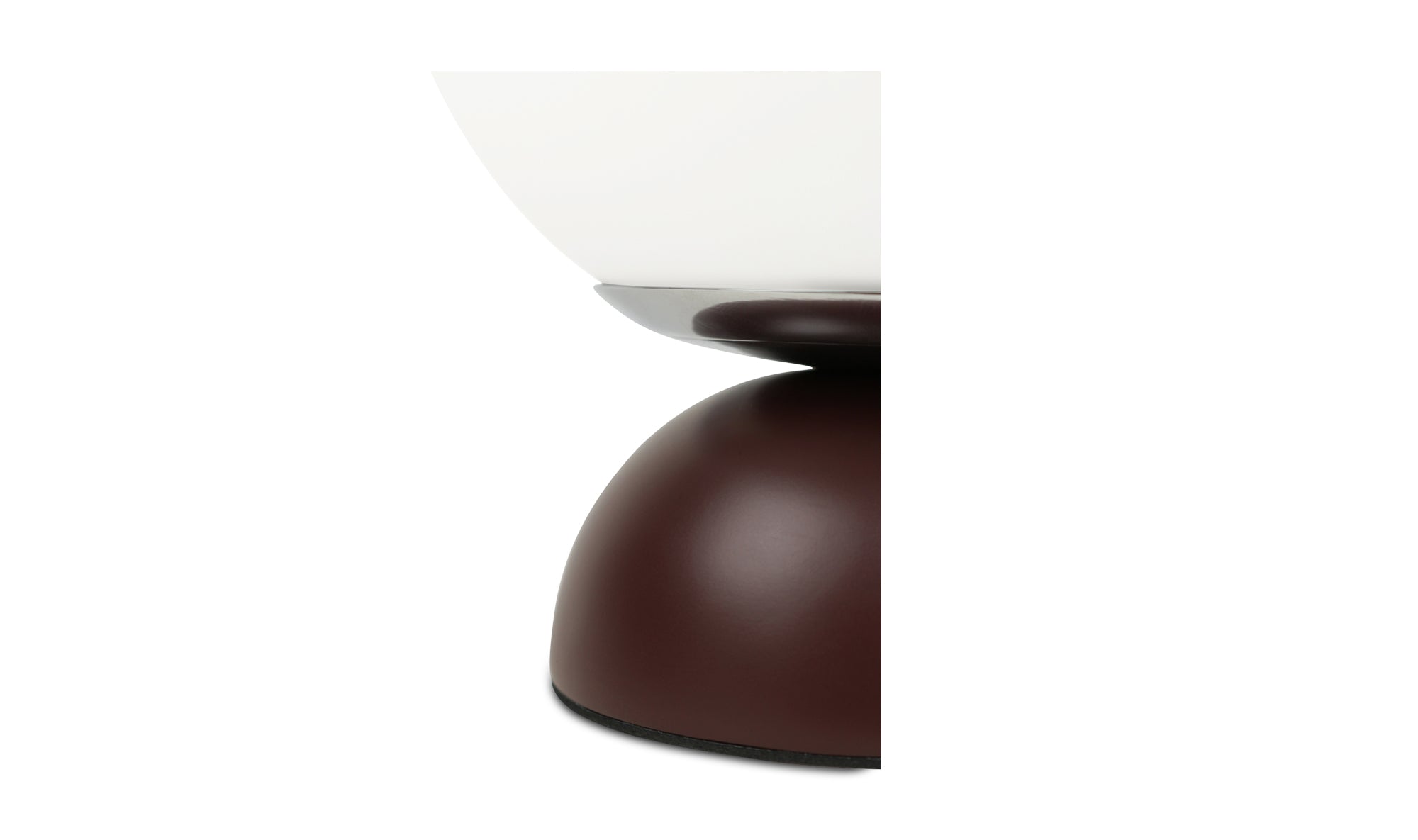 Close-up of a modern table lamp with a white shade and brown base on a white background