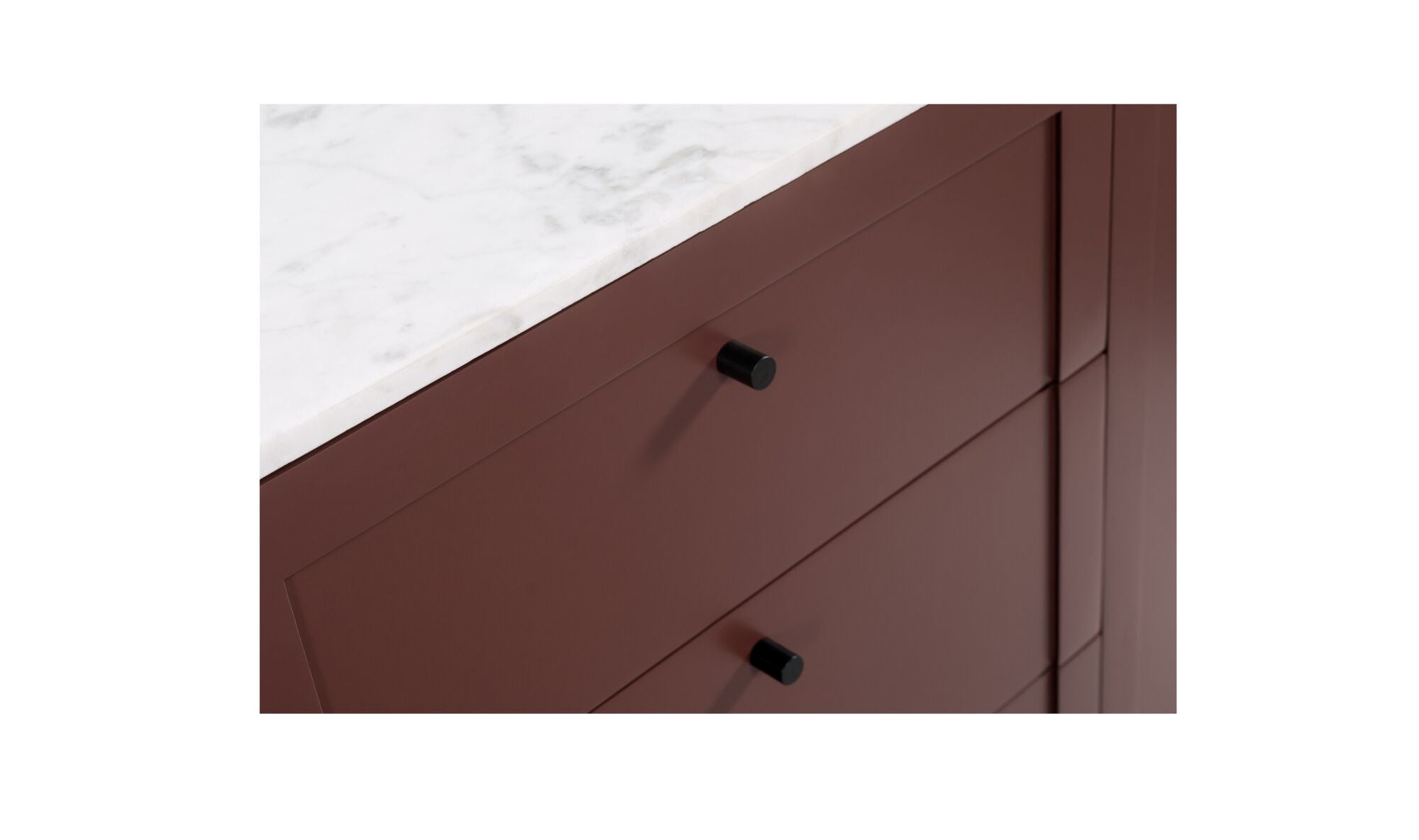 Close-up of a brown cabinet with black handles on a white background