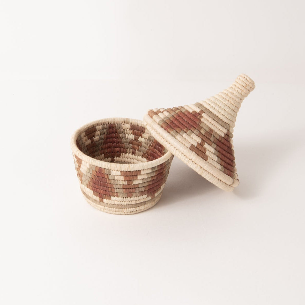 Woven basket with a lid on a white background