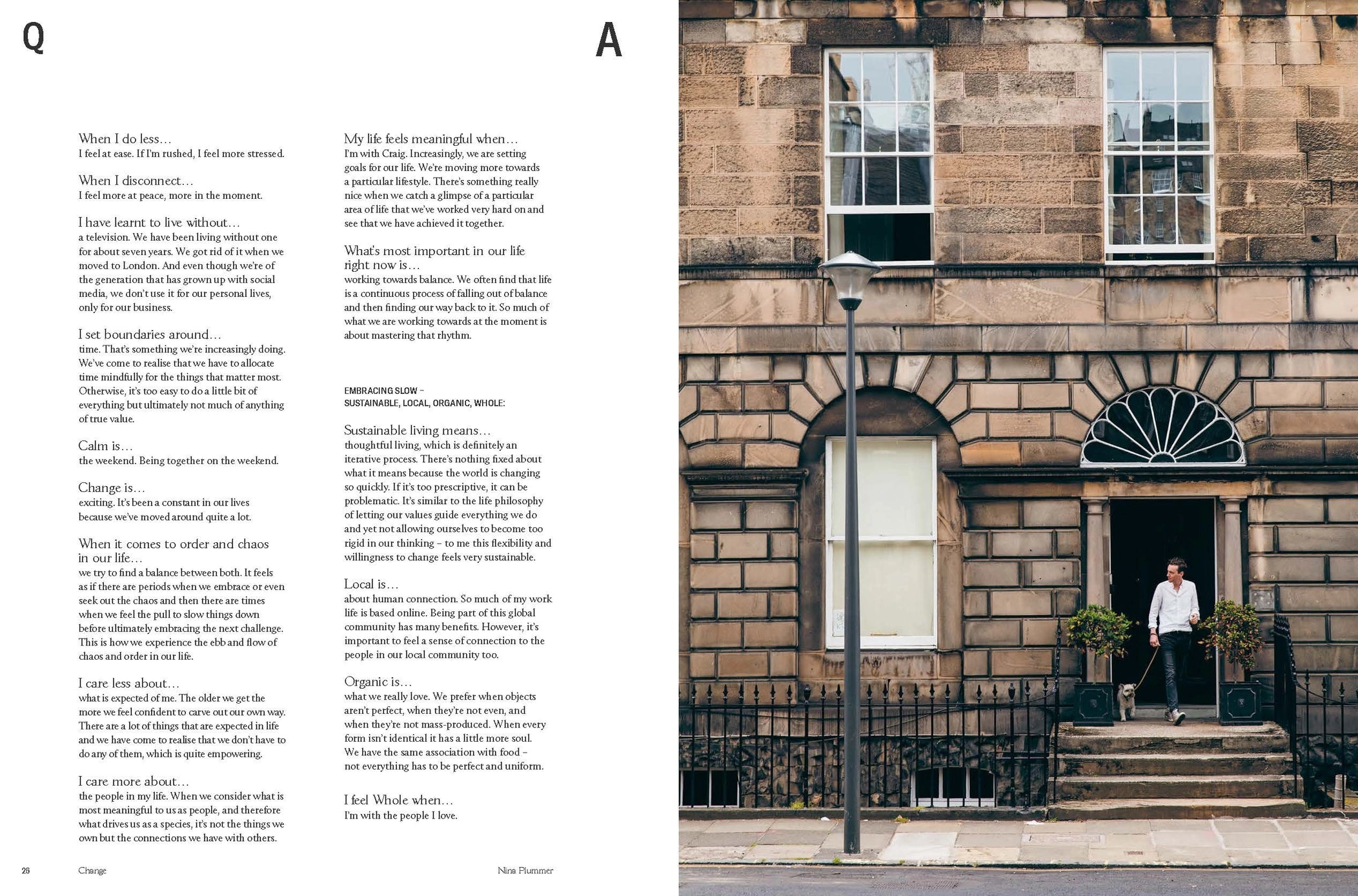 Person standing on the steps of a stone building with architectural details
