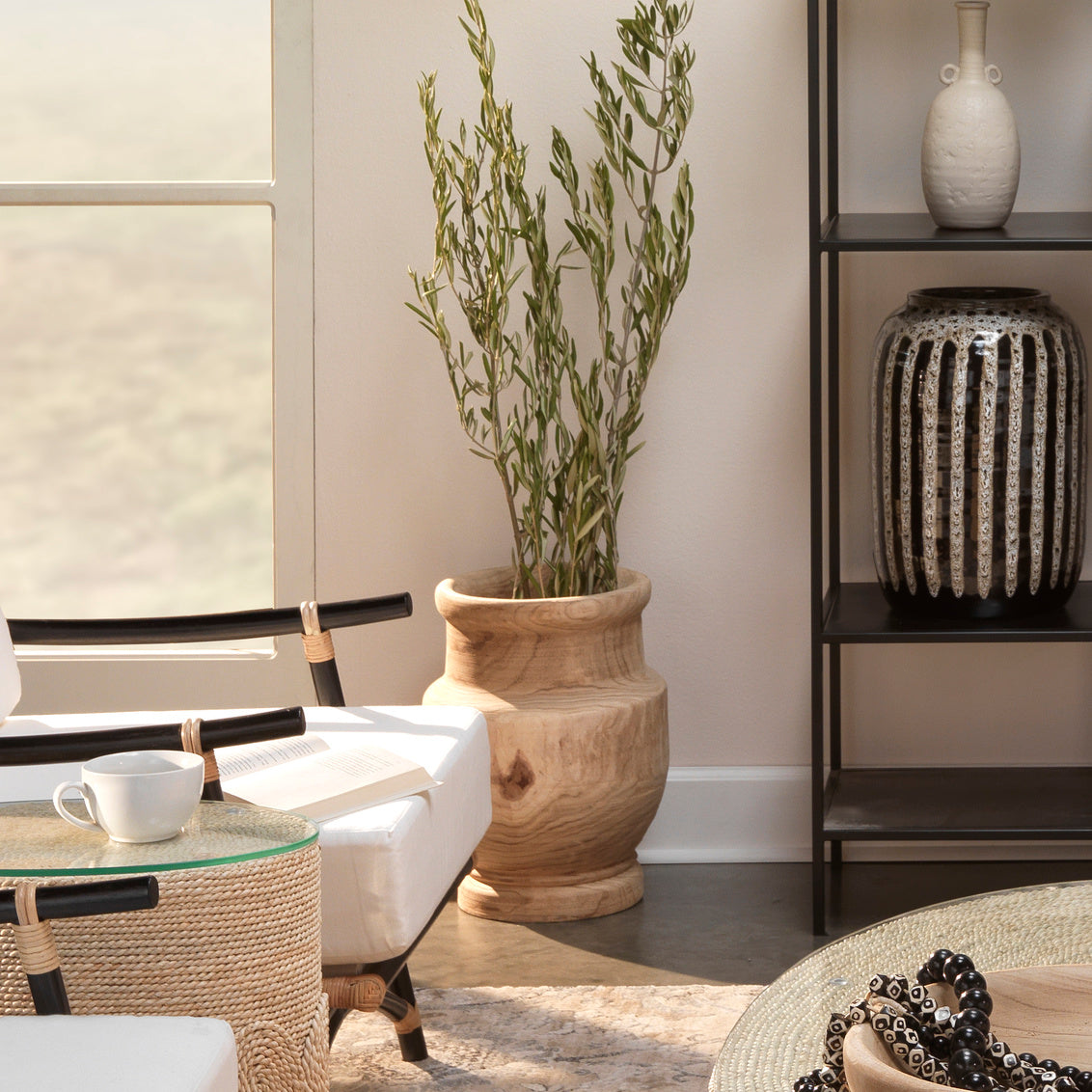 Living room with a vase, plant, and coffee table