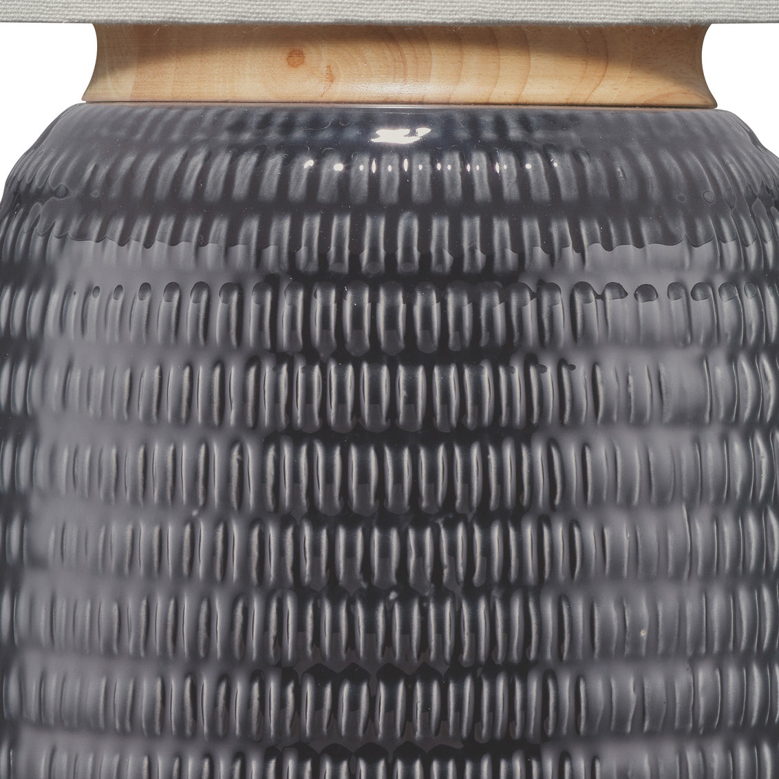 Close-up of a textured navy ceramic table lamp