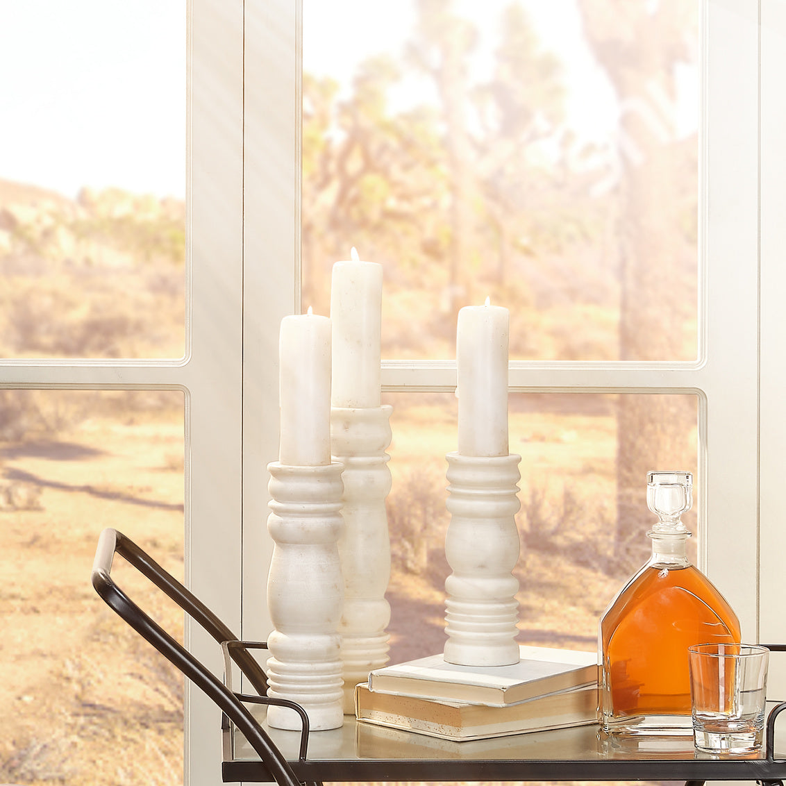 Three white textured vases of different heights on a white background