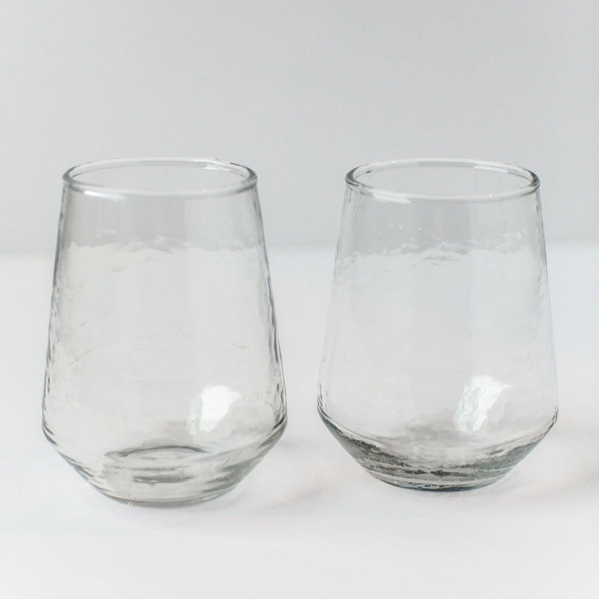Two clear glass tumblers on a white background