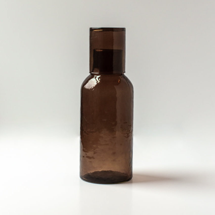 Brown glass carafe on a white background