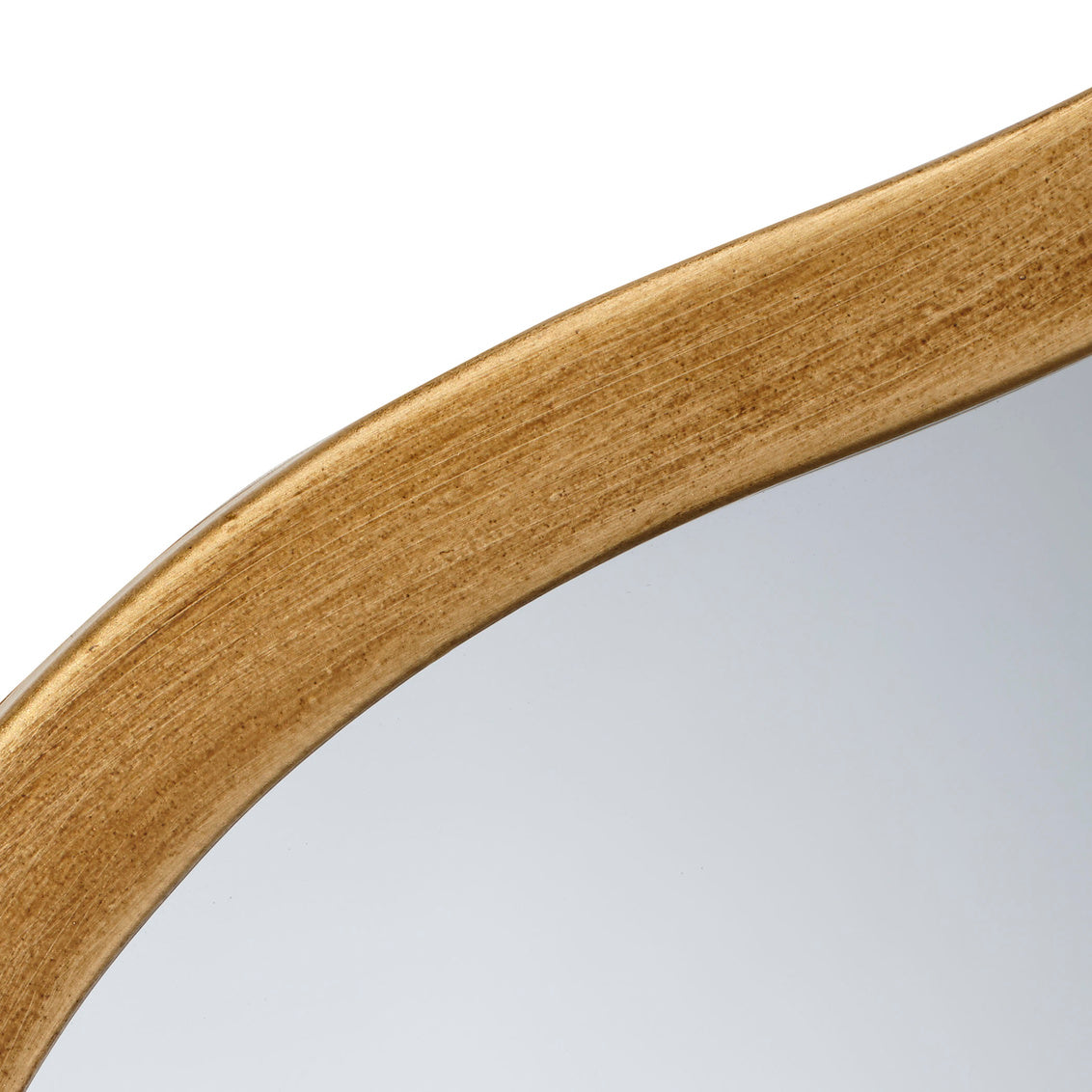 Close-up of a brass mirror frame on a white background