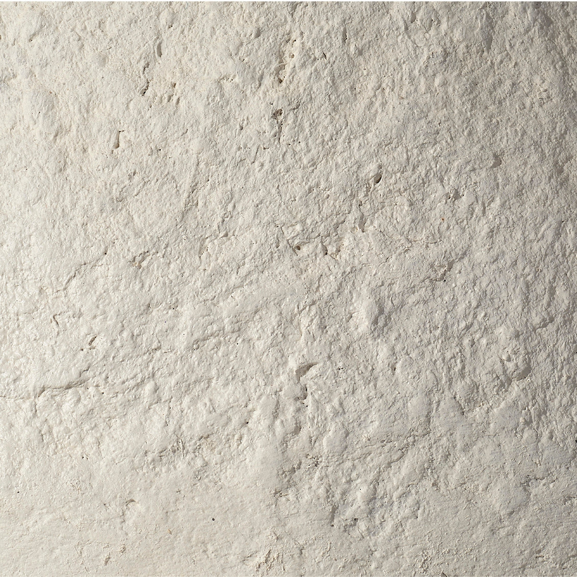 Close-up of textured beige stone surface