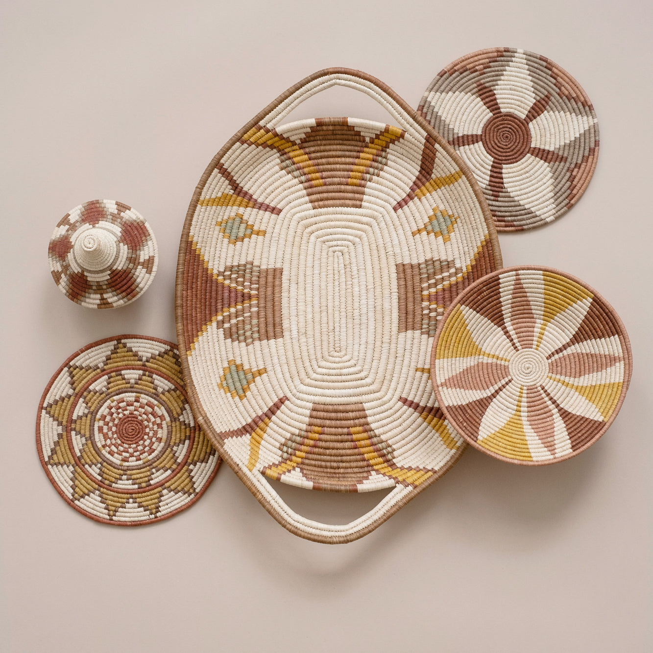 Set of woven baskets with geometric patterns on a beige background