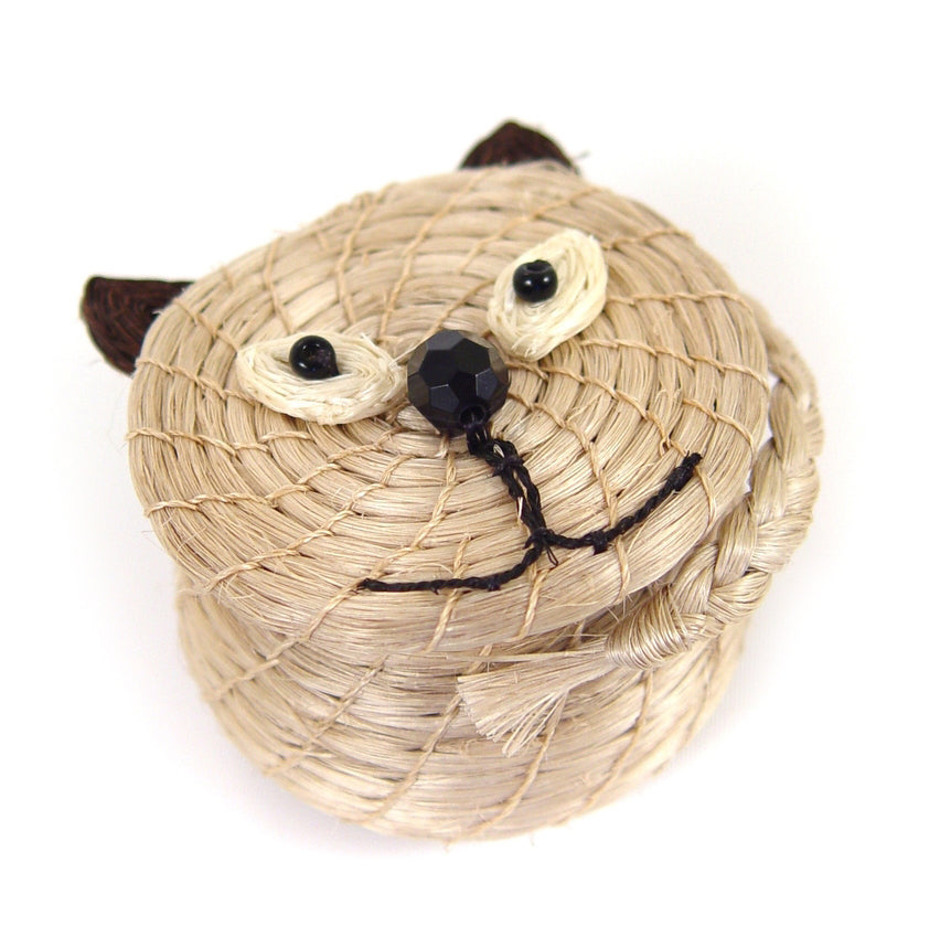 Woven cat-shaped basket with black eyes and mouth on a white background