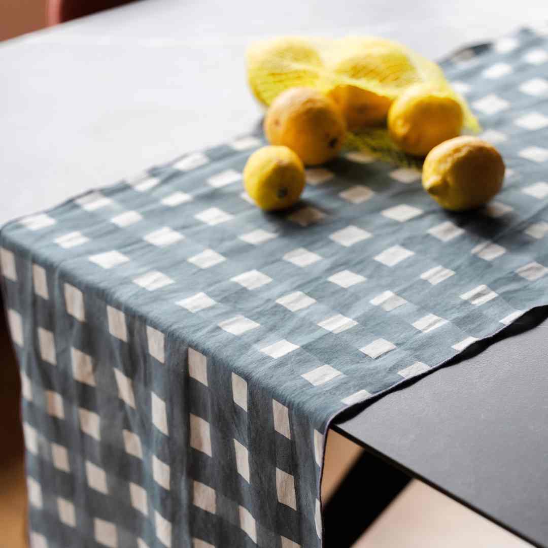 Checkered blue tablecloth with lemons on a table