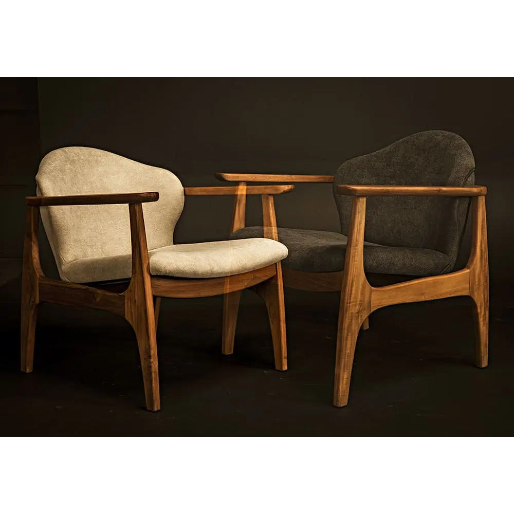 Two wooden armchairs with fabric seats on a dark background