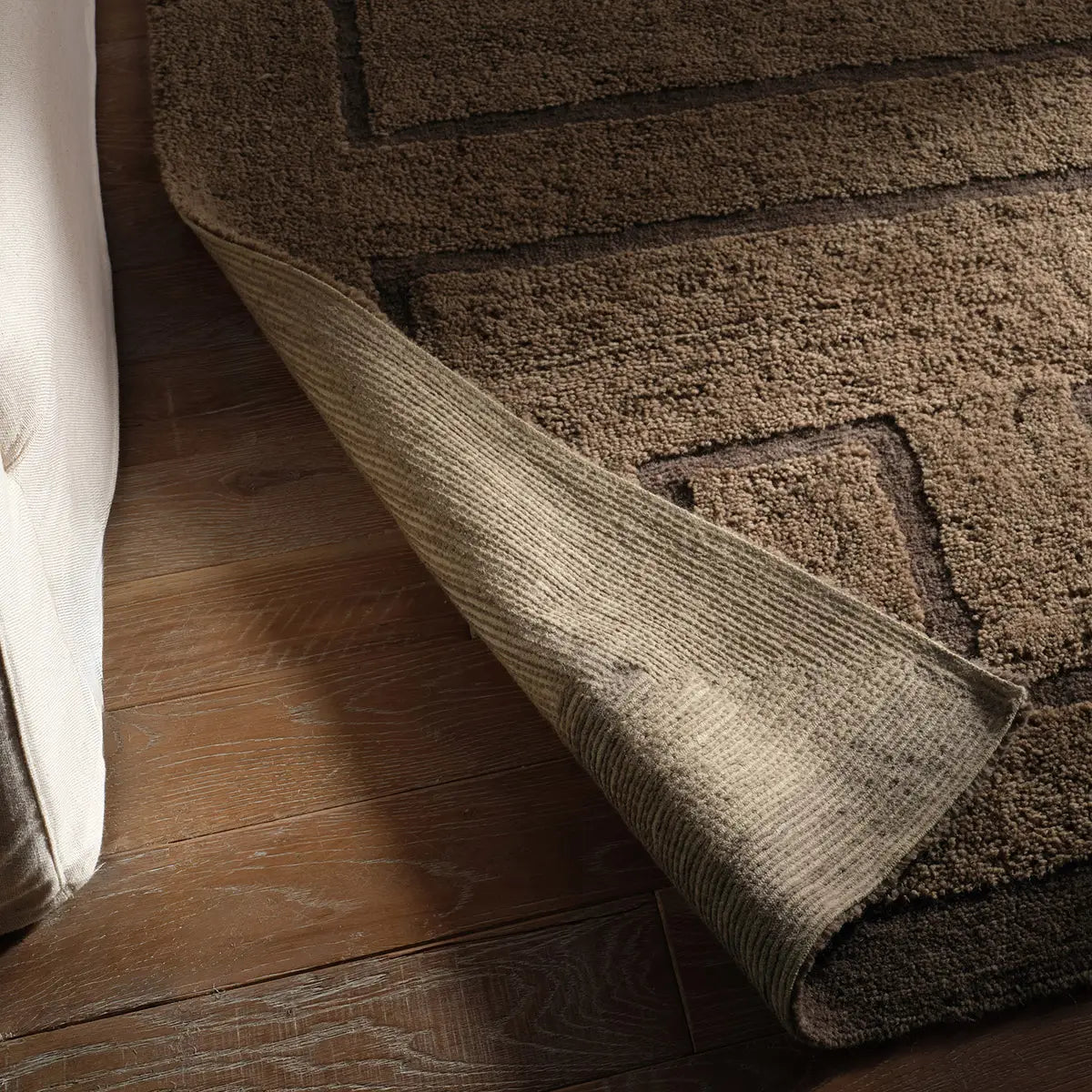 Brown area rug on a wooden floor