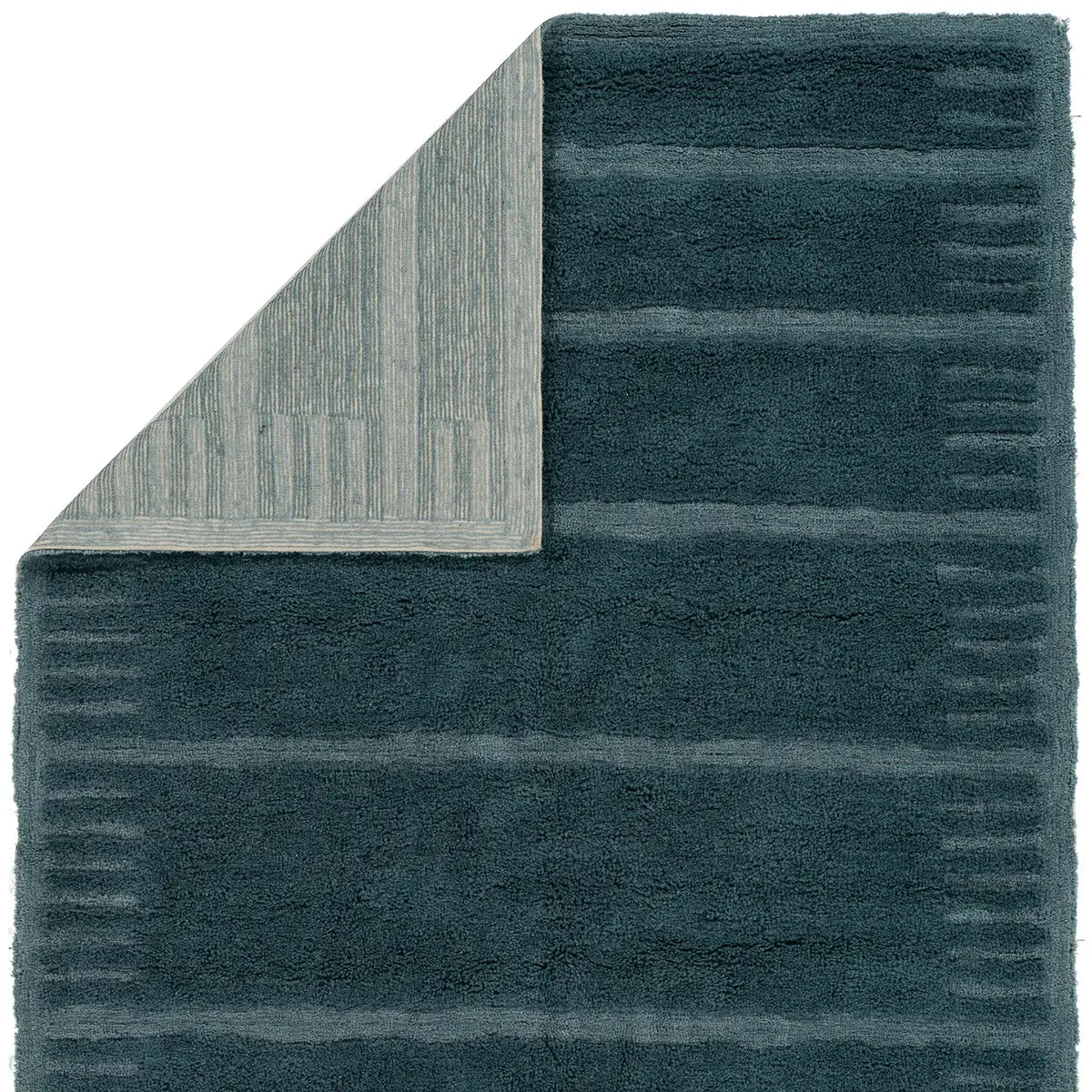 Teal bath mat with textured pattern on a white background