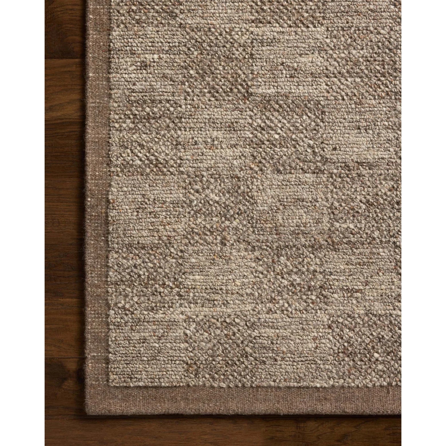 Textured brown rug on a wooden floor