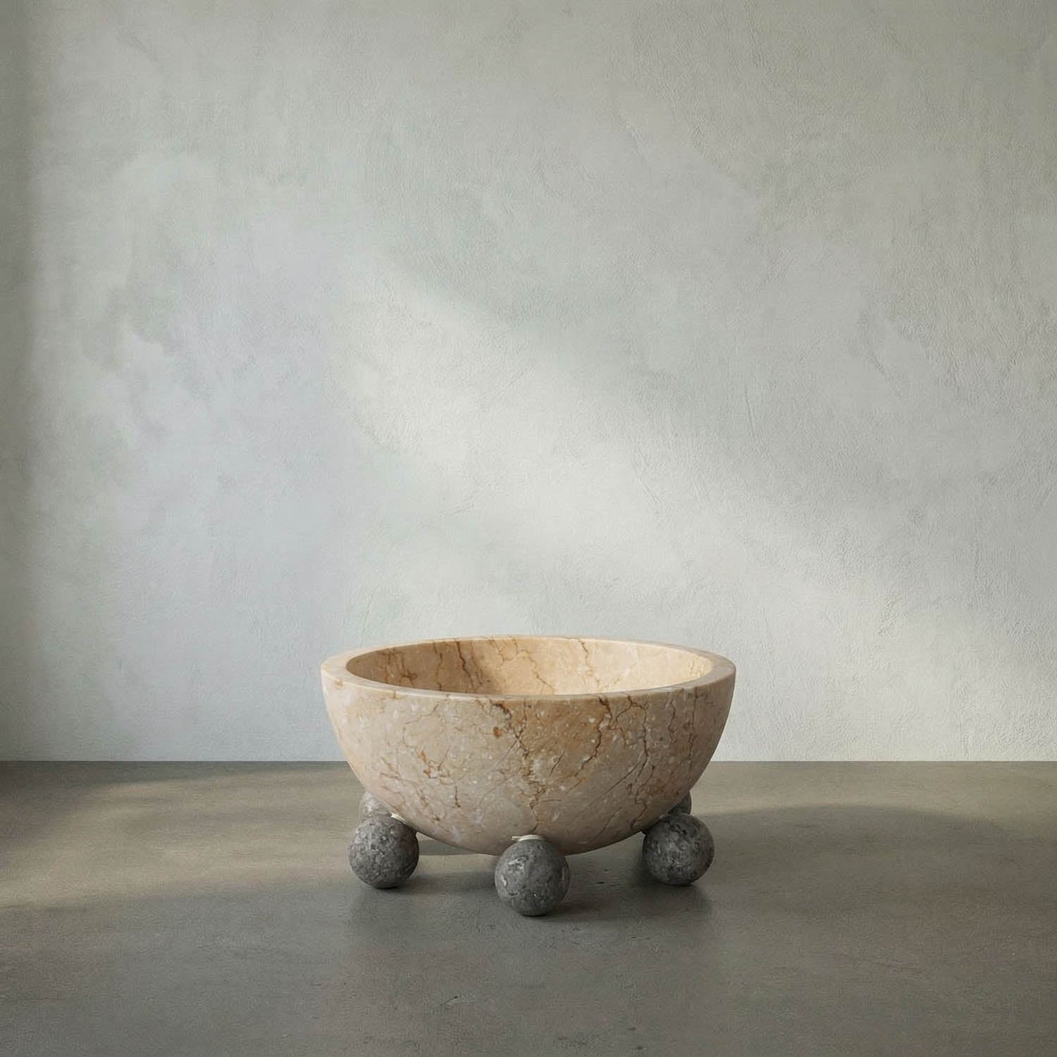 Marble bowl with spherical base on a neutral background