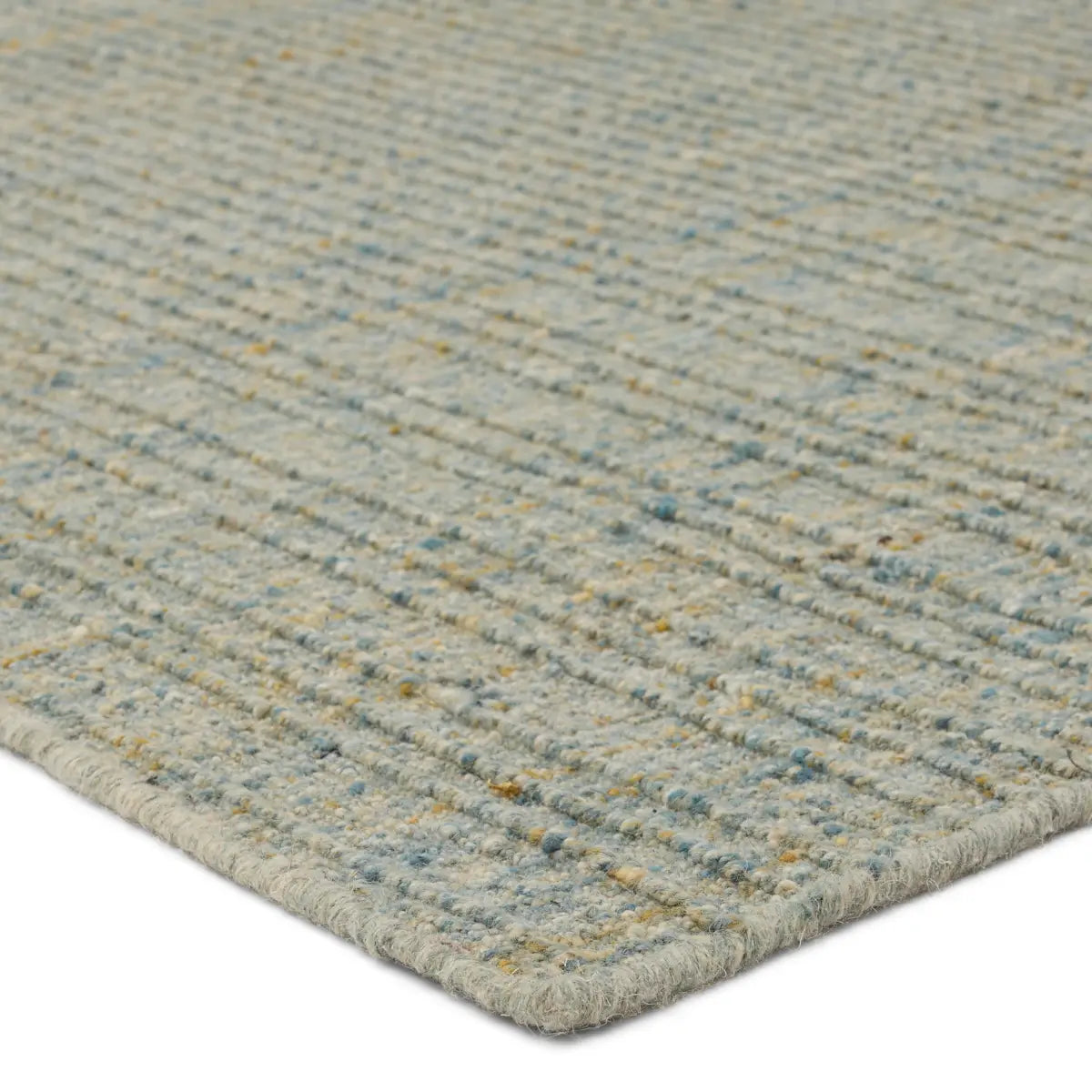 Close-up of a textured rug with a neutral color palette on a white background
