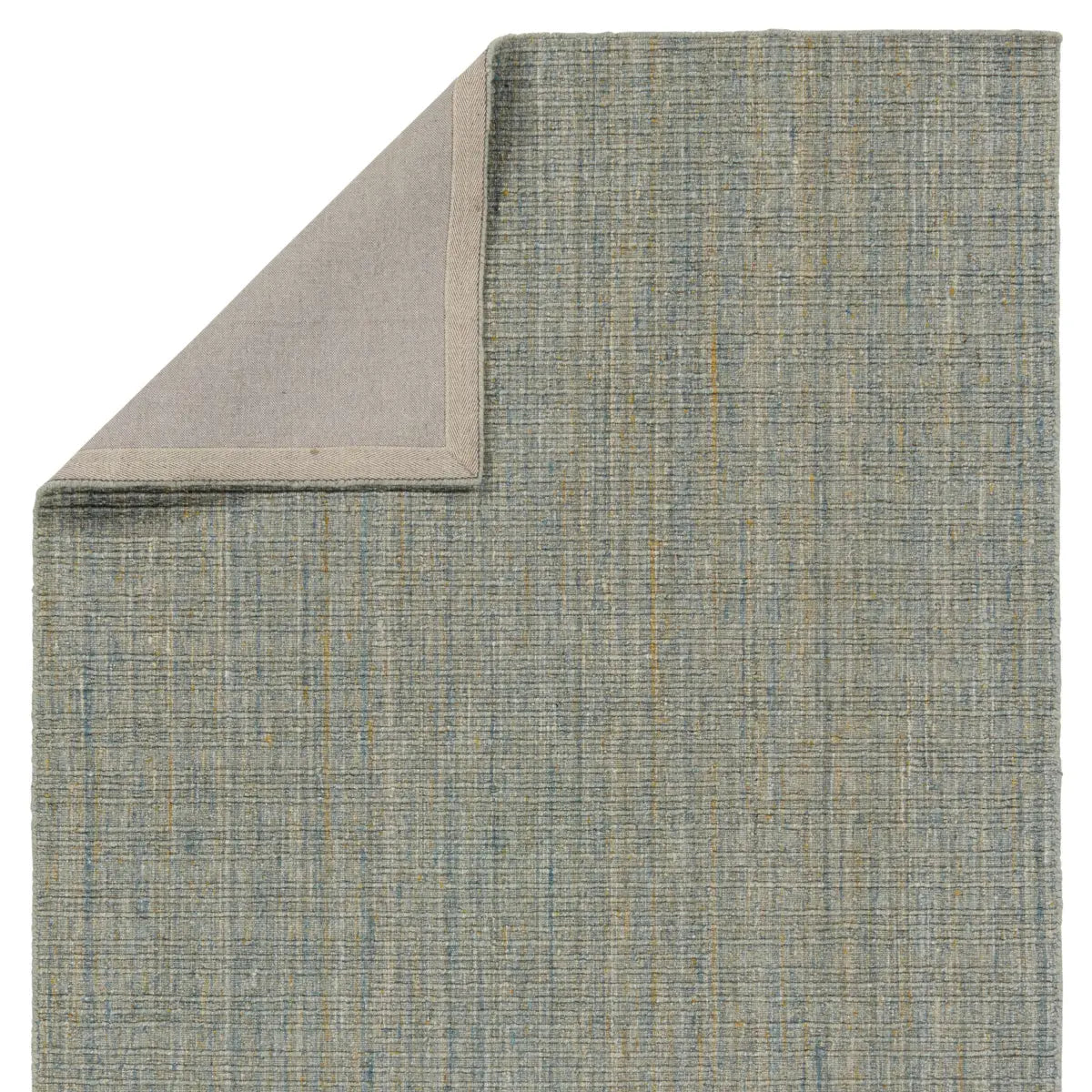 Textured green rug corner on a white background