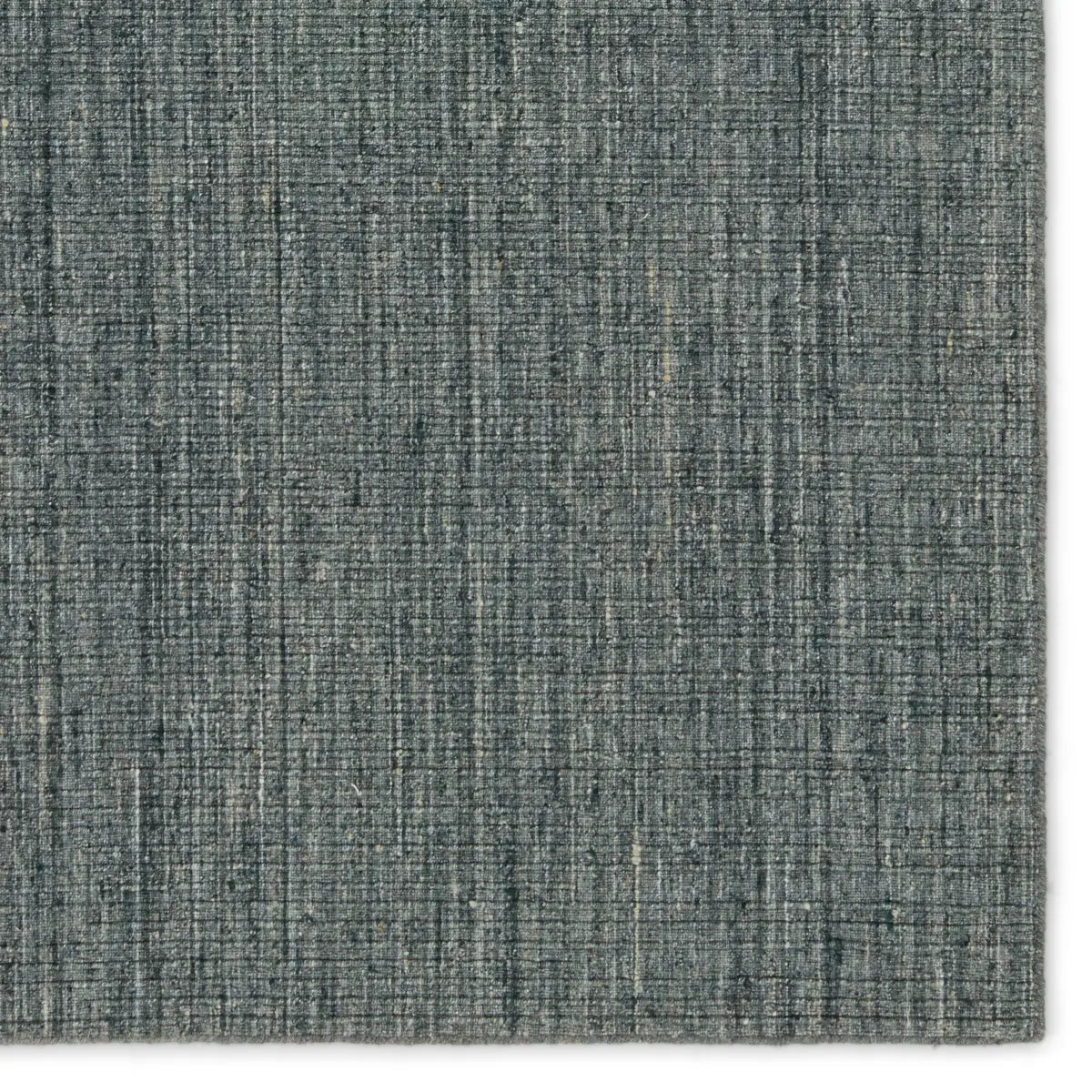 A textured blue rug on a white background