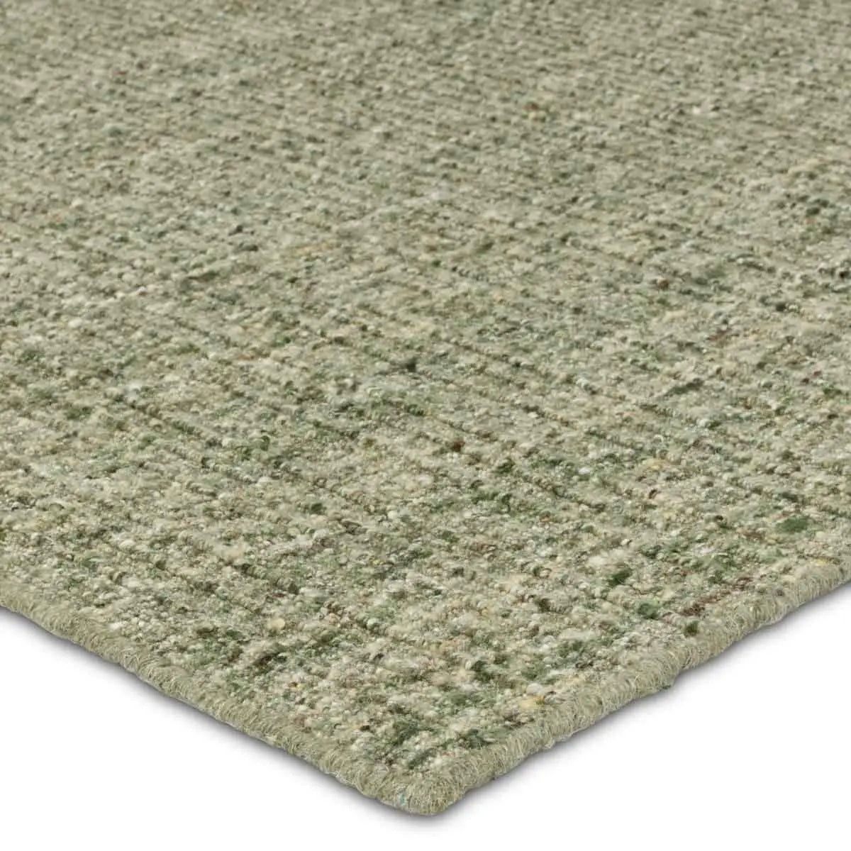 Close-up of a green textured rug corner