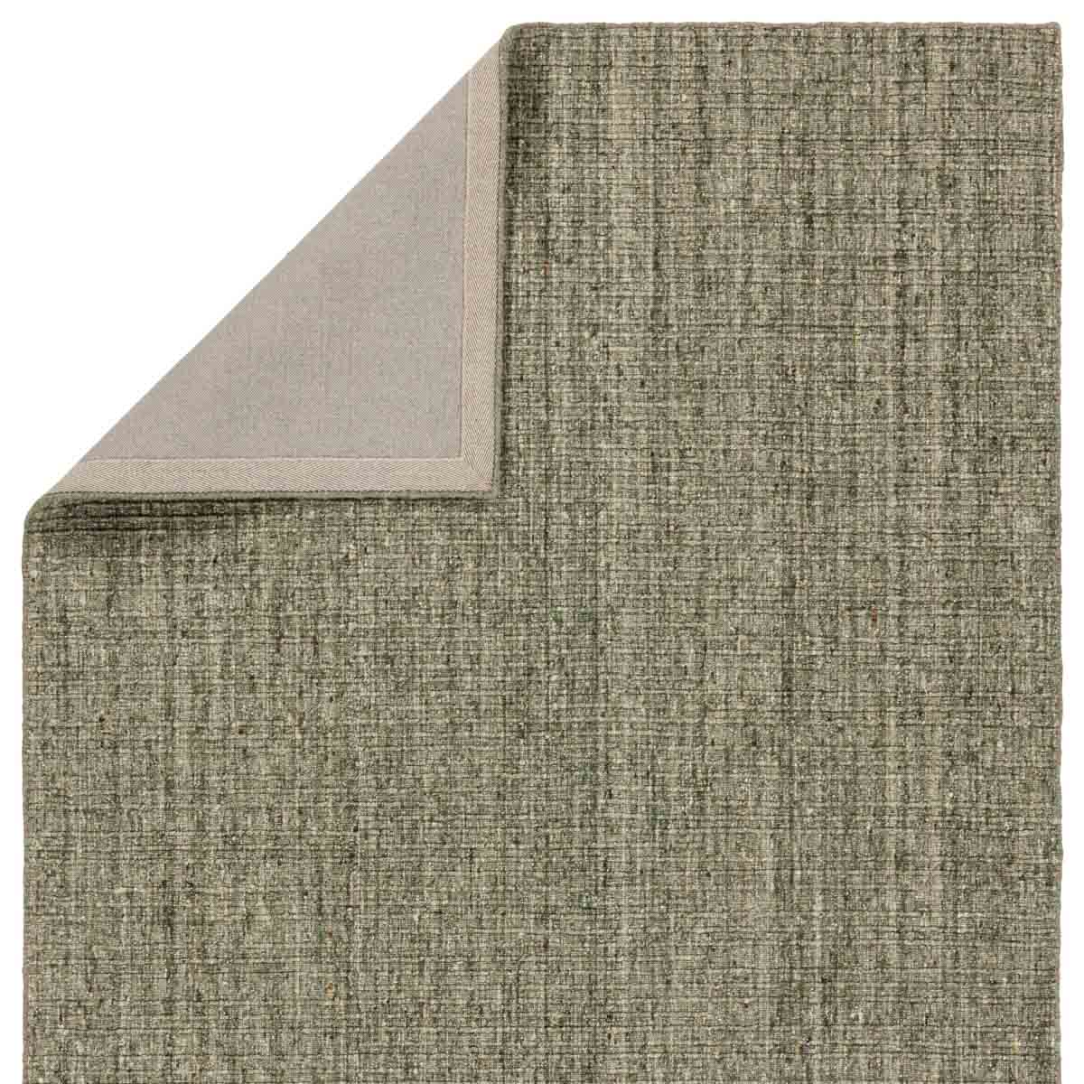 Textured gray rug corner on a white background