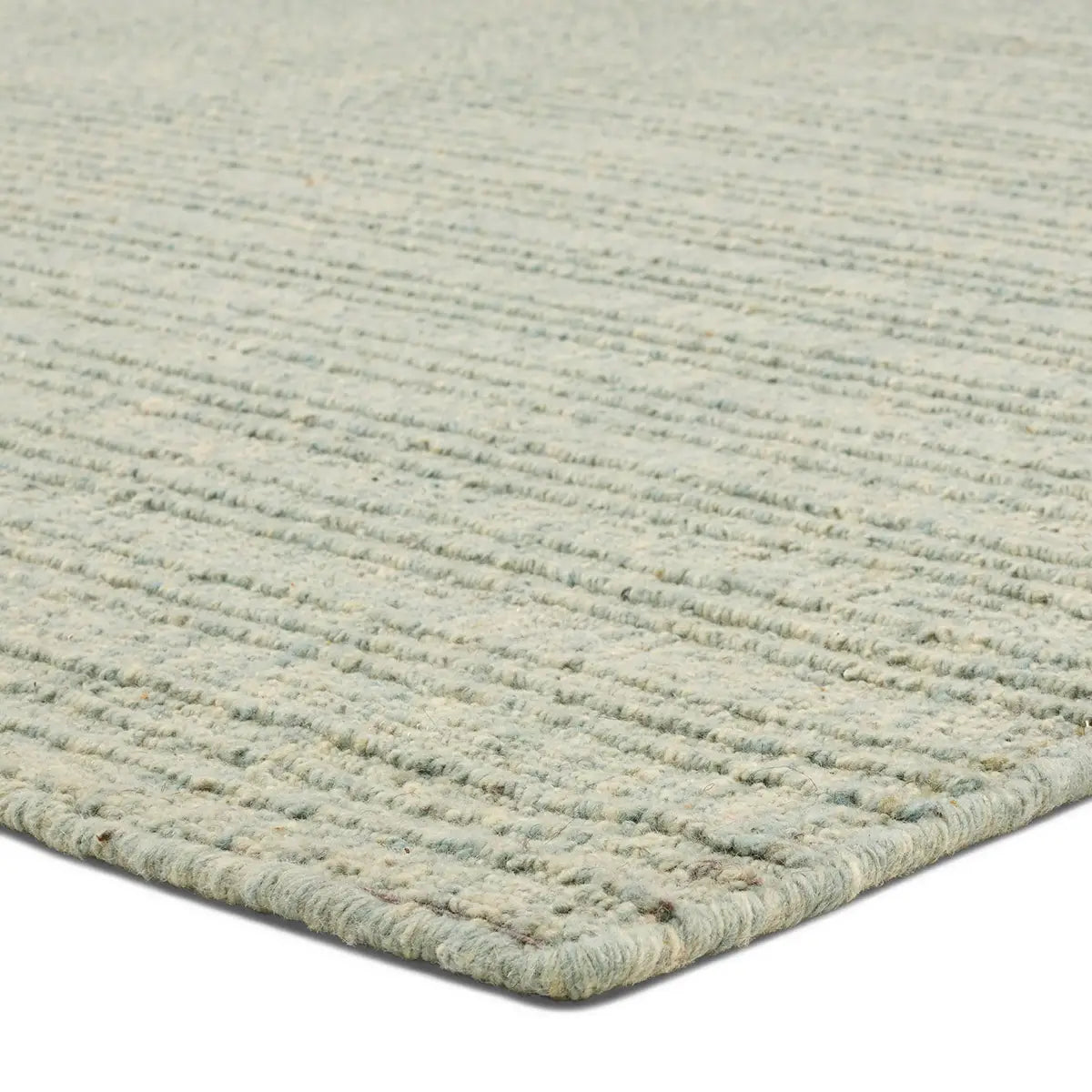 Close-up of a textured green rug on a white background