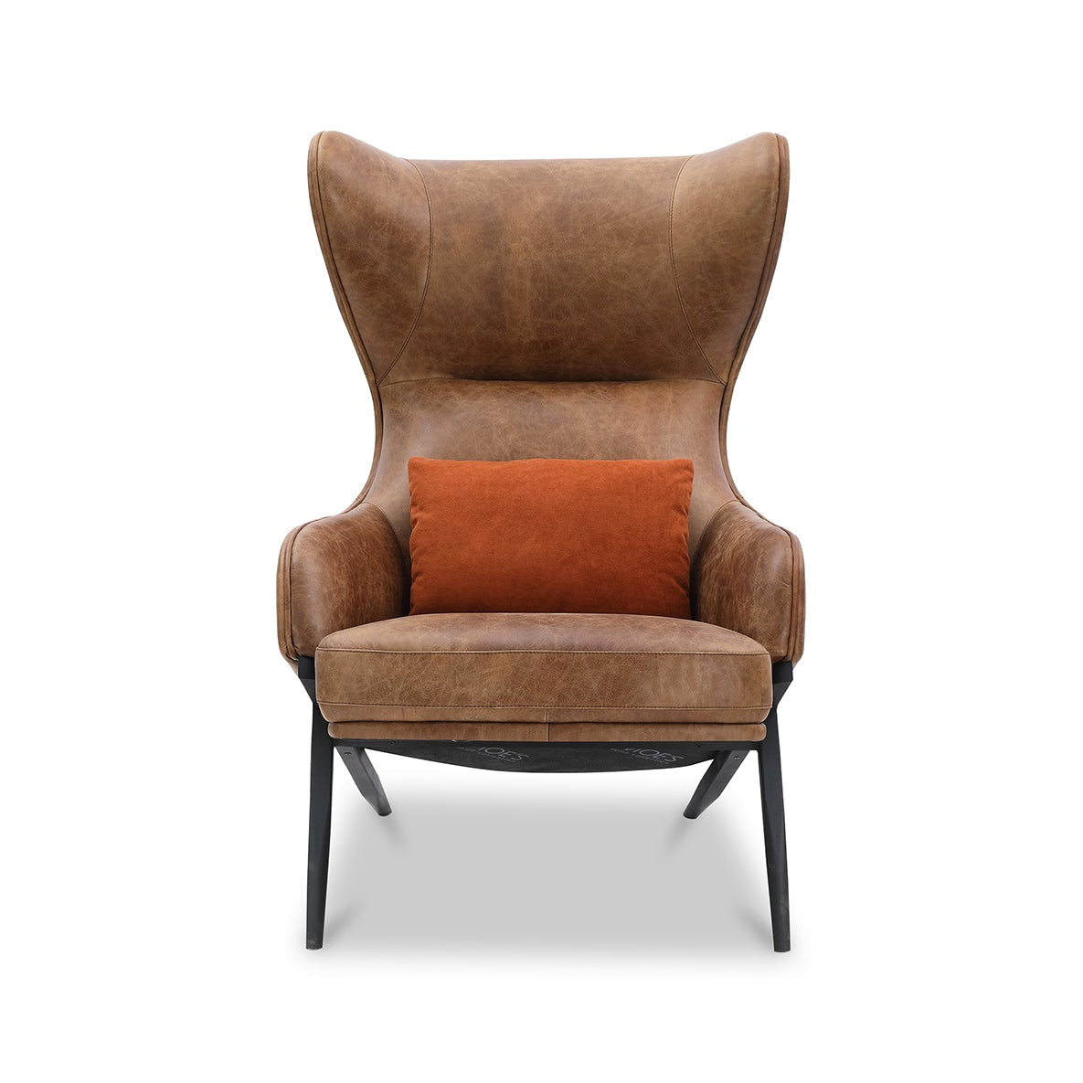 A brown leather wingback armchair with a small orange accent pillow, set against a plain white background.