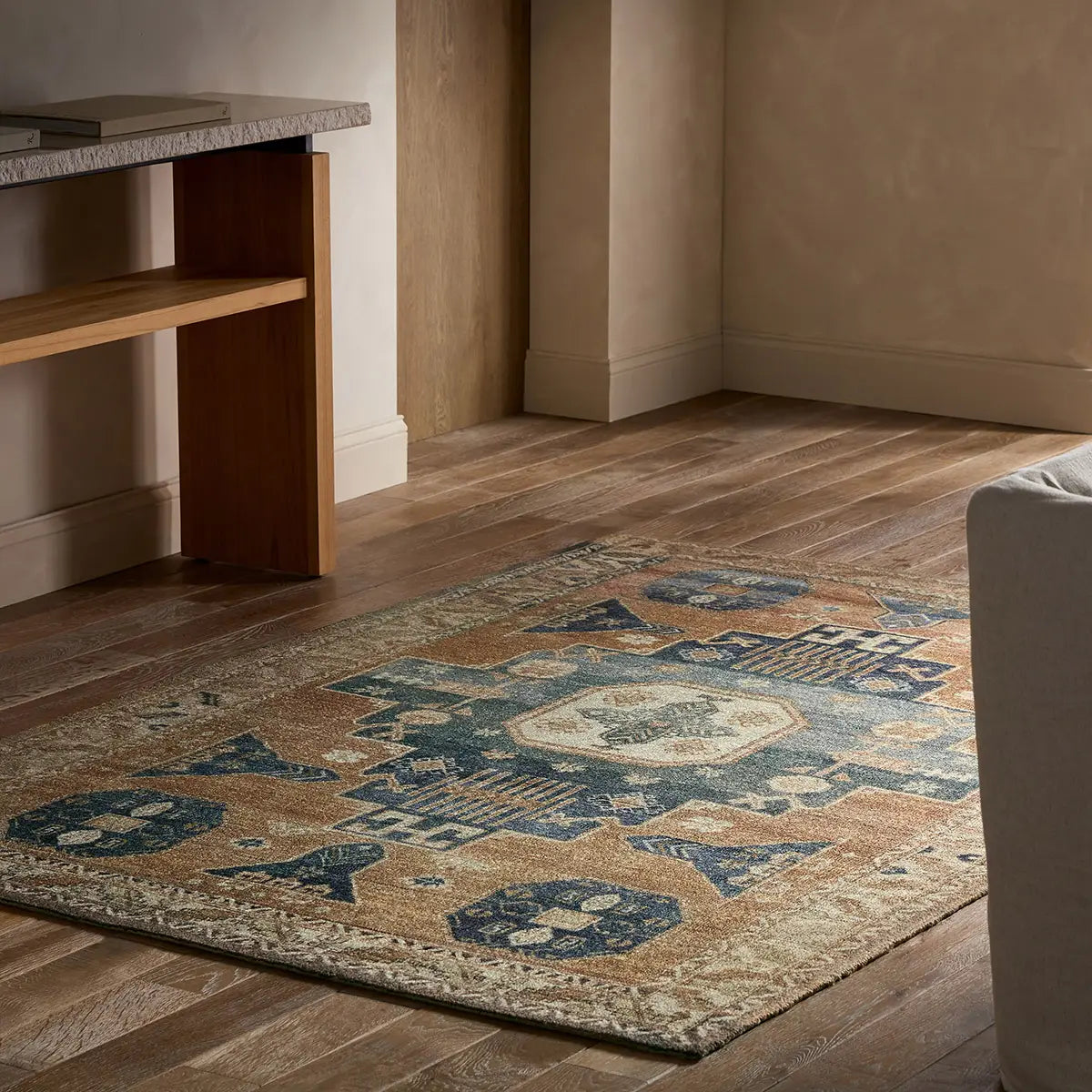 Decorative rug with geometric pattern on wooden floor