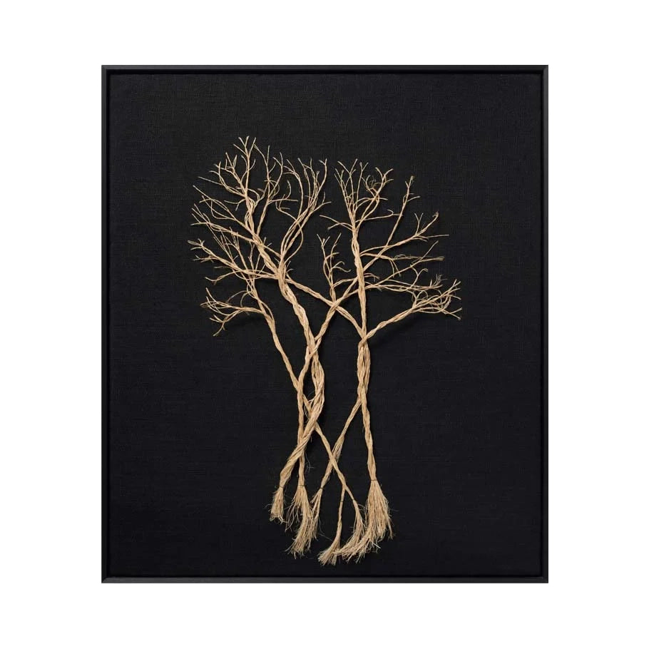 A framed wall art piece featuring three intertwined bare tree branches or roots in a natural tan color against a textured black background, enclosed in a thin black frame.