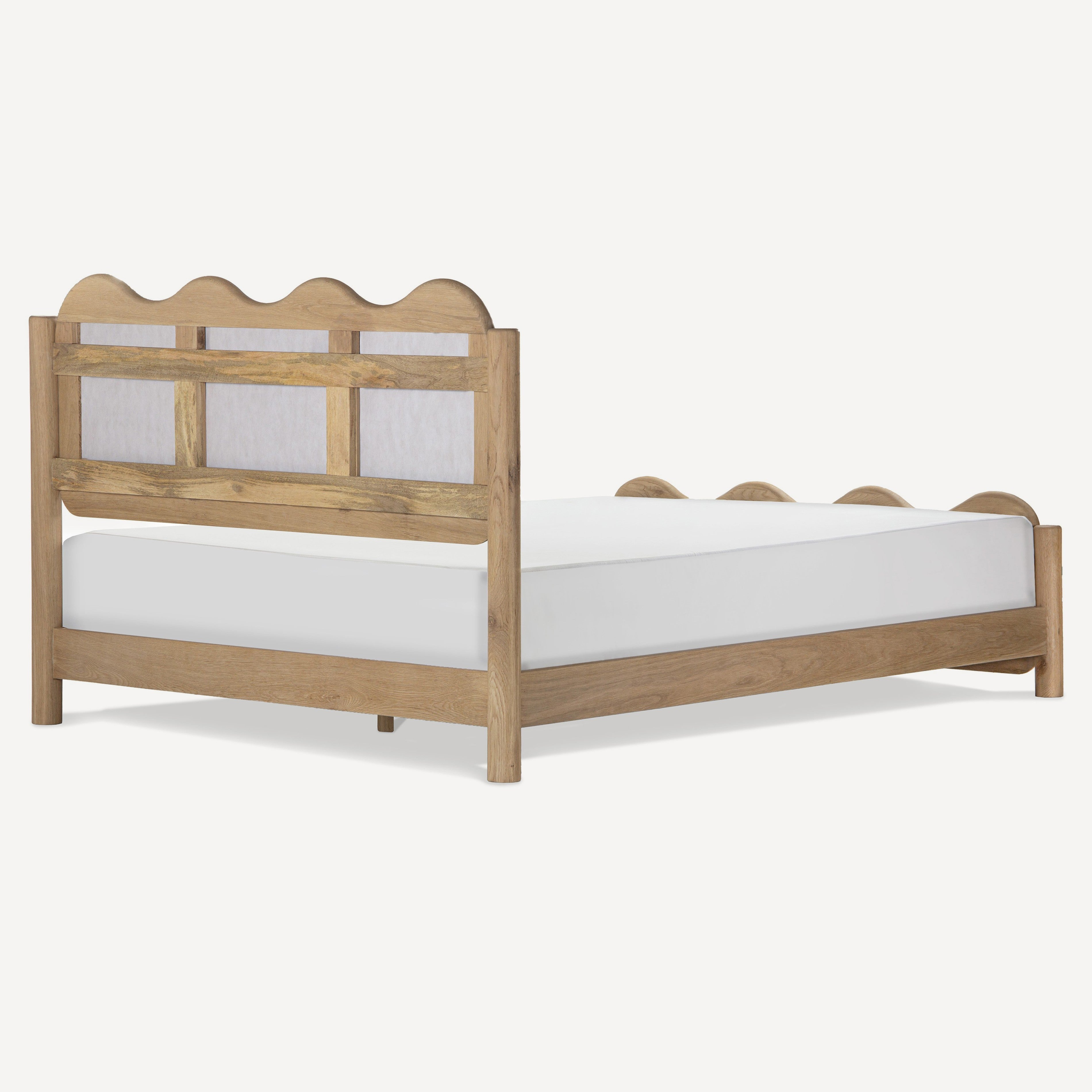 A light natural wood bed frame with a scalloped headboard and footboard, shown with a white mattress on a clean white background.