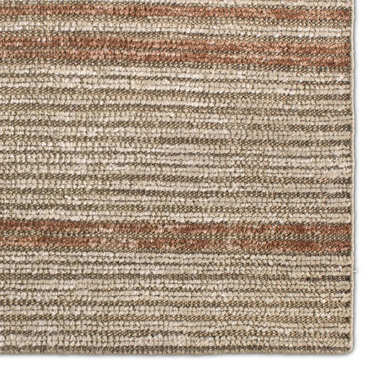 Textured area rug with a striped pattern in earthy tones on a white background