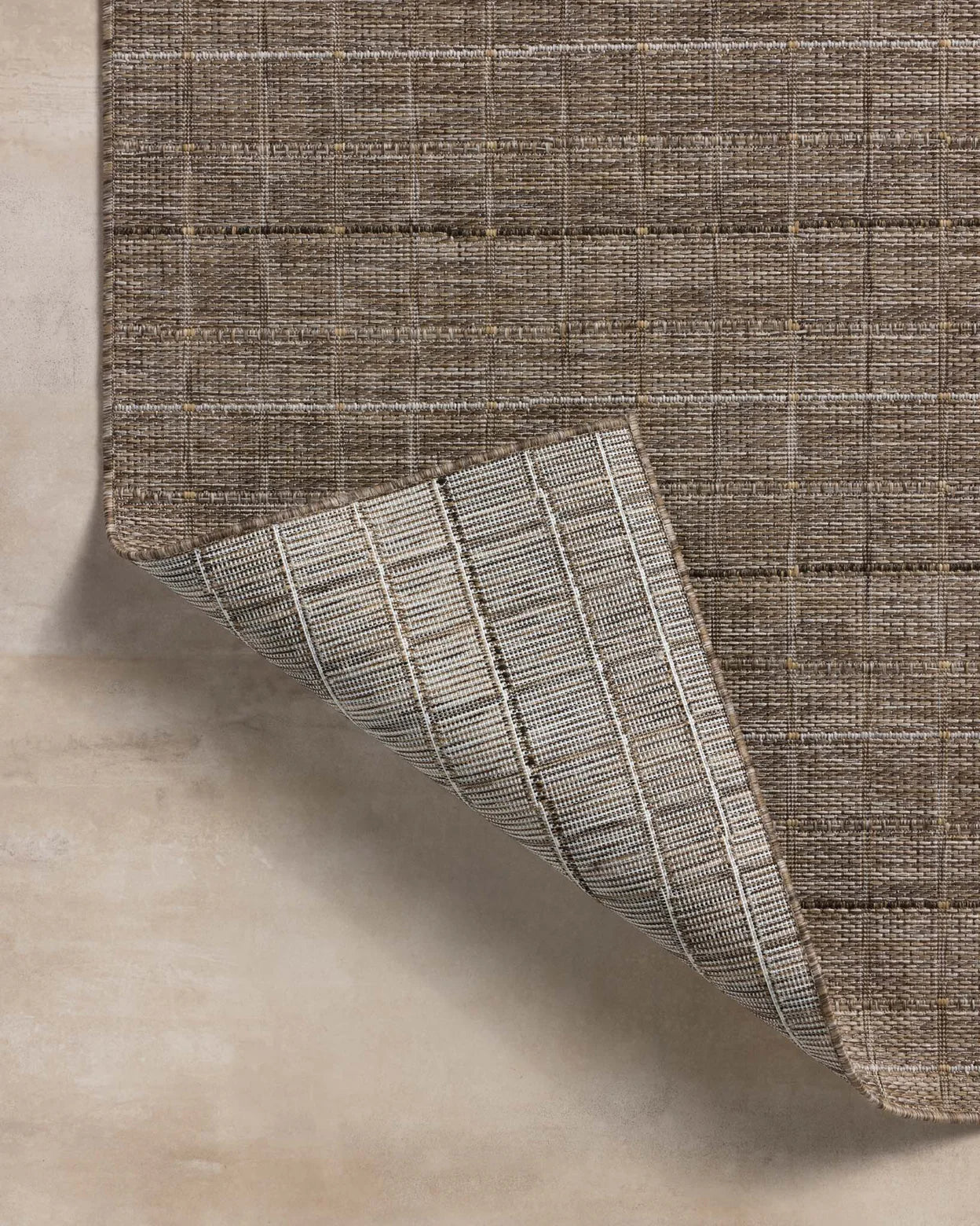 Textured brown fabric with a woven pattern on a neutral background