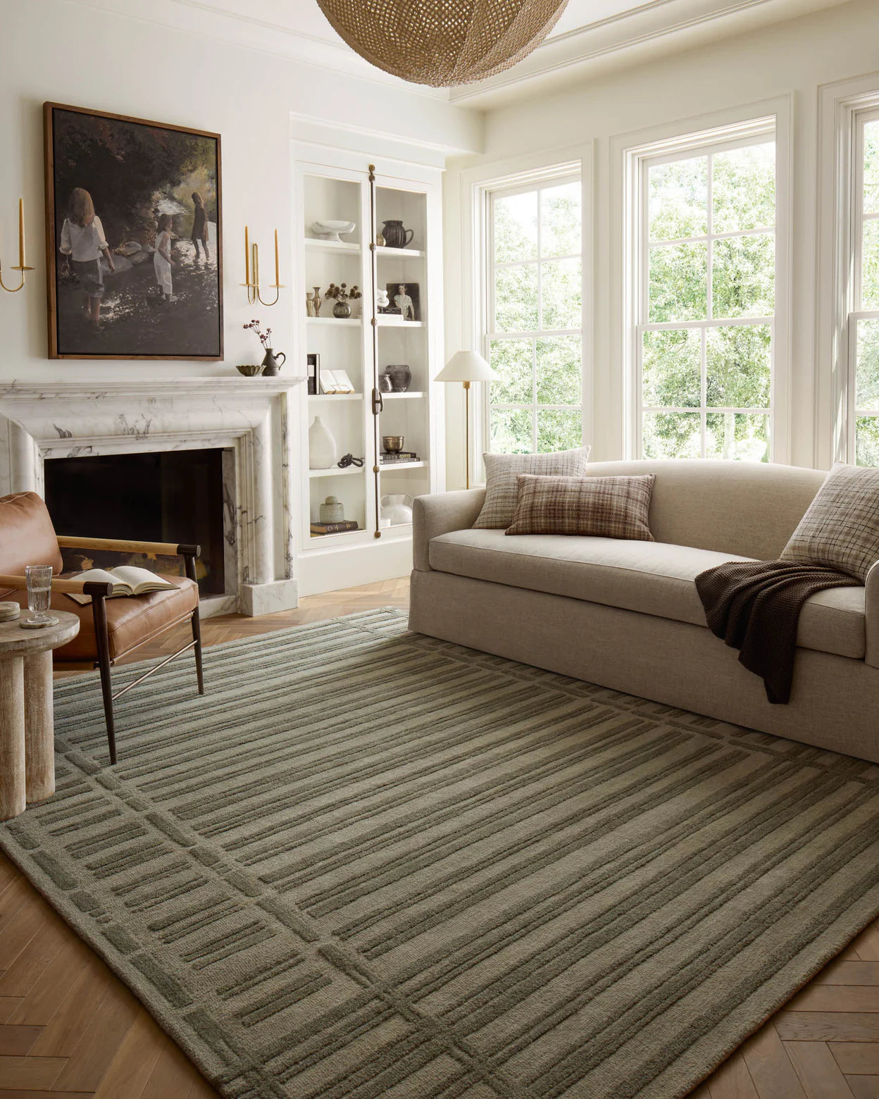 A rectangular, striped rug with varying shades of gray and beige, representing a geometric pattern.
