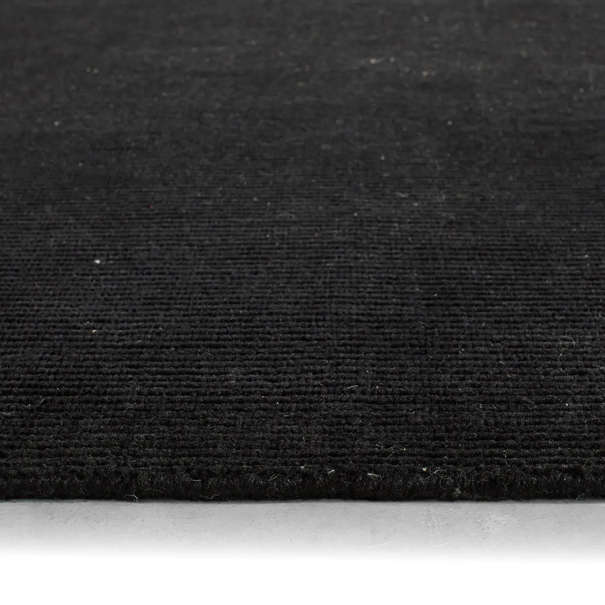 Close-up of black fabric texture on a white background