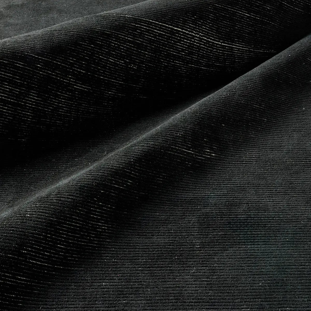 Close-up of black velvet fabric with a textured surface