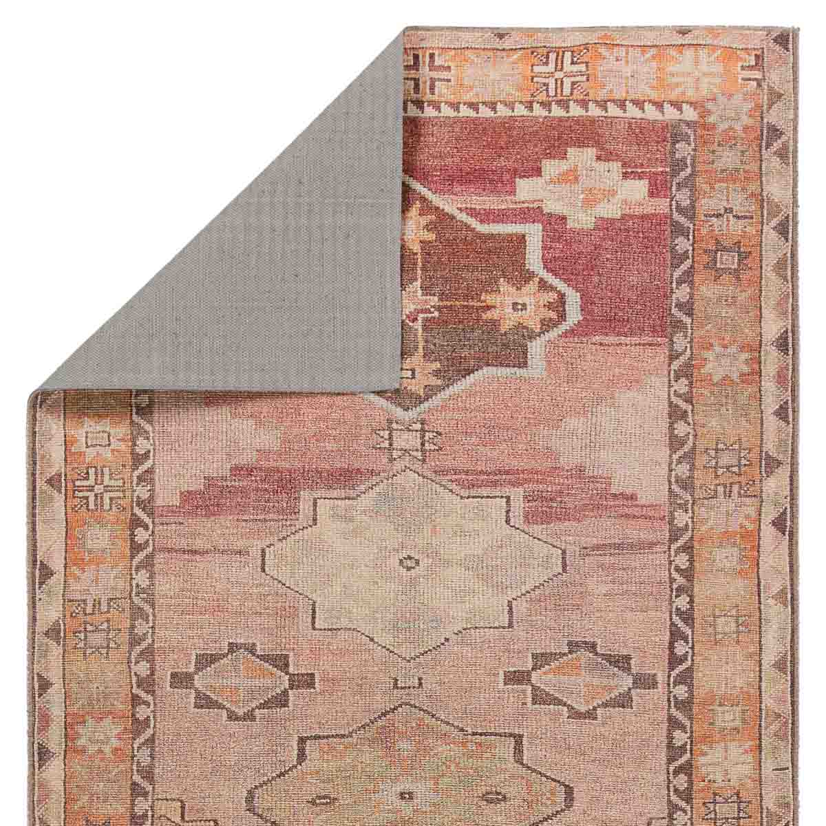 Patterned rug with geometric design on a plain background