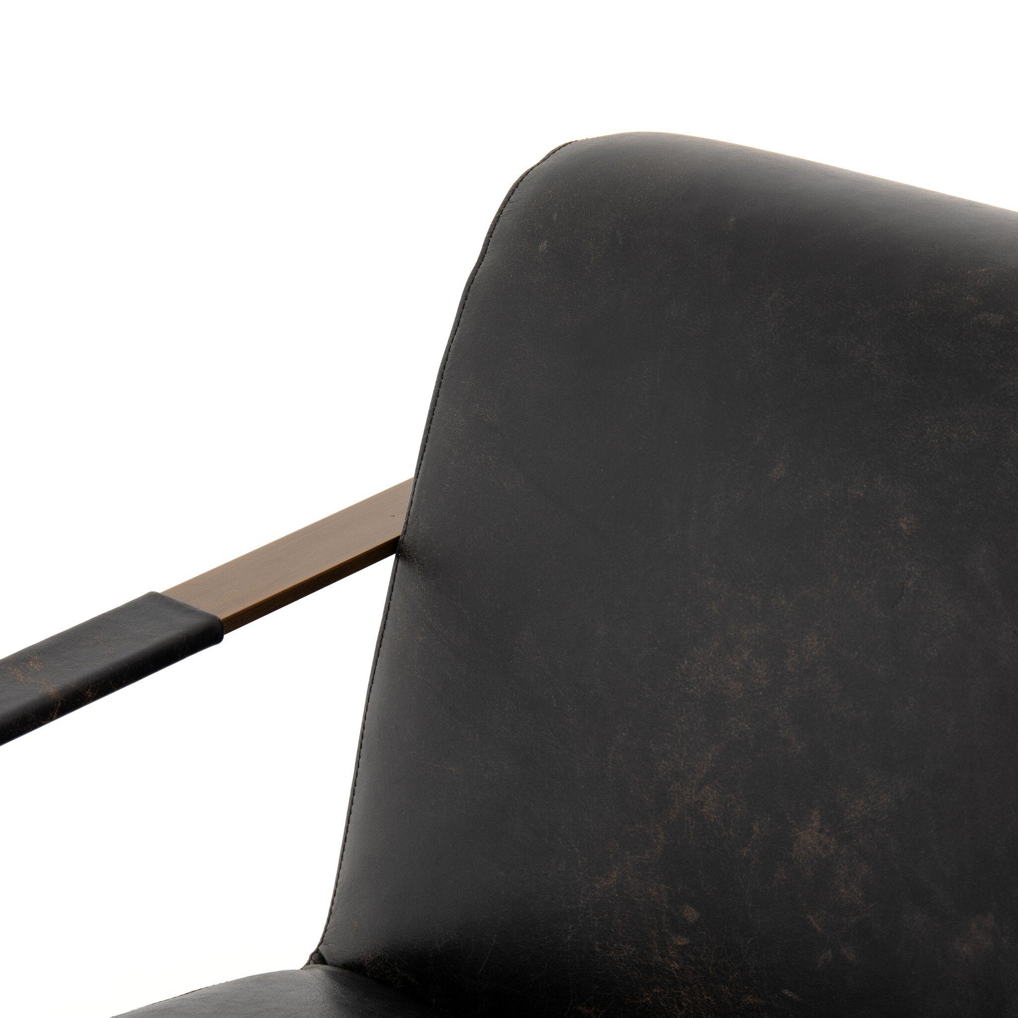 Close-up of a black leather chair with a wooden armrest on a white background