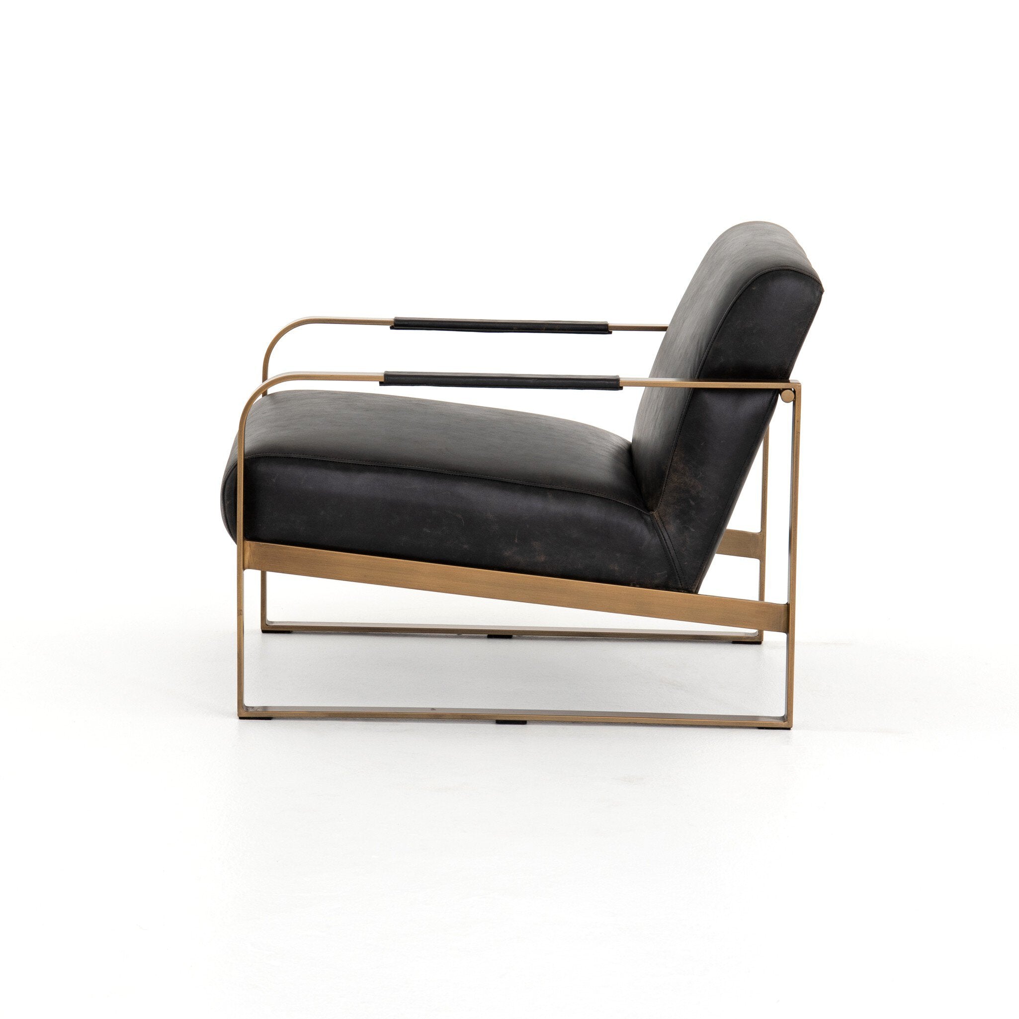 Modern chair with black leather seat and gold metal frame on a white background