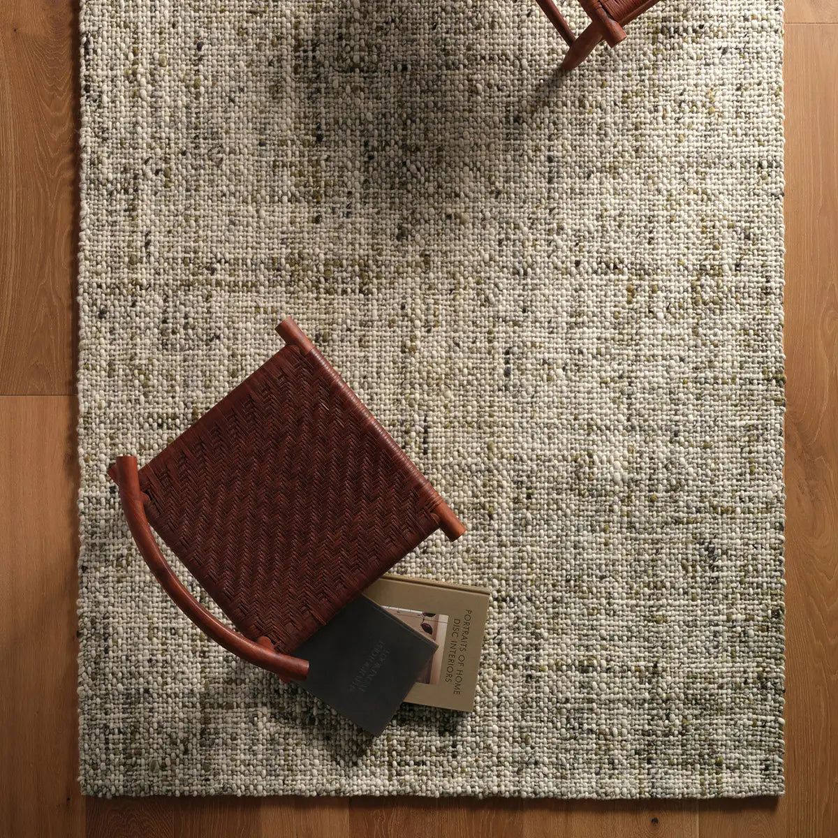 Textured area rug with a small brown chair on top