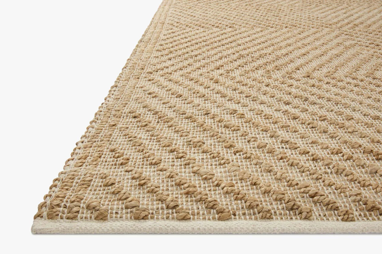 Beige woven rug on a plain background