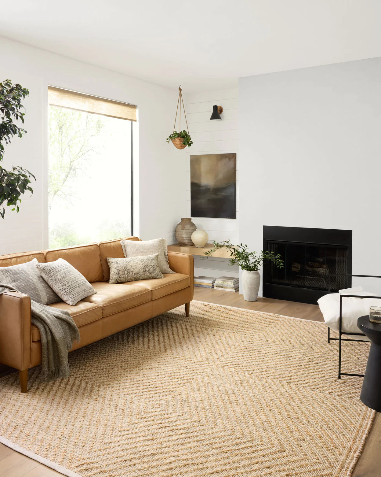 Modern living room with a brown sofa, rug, and fireplace.