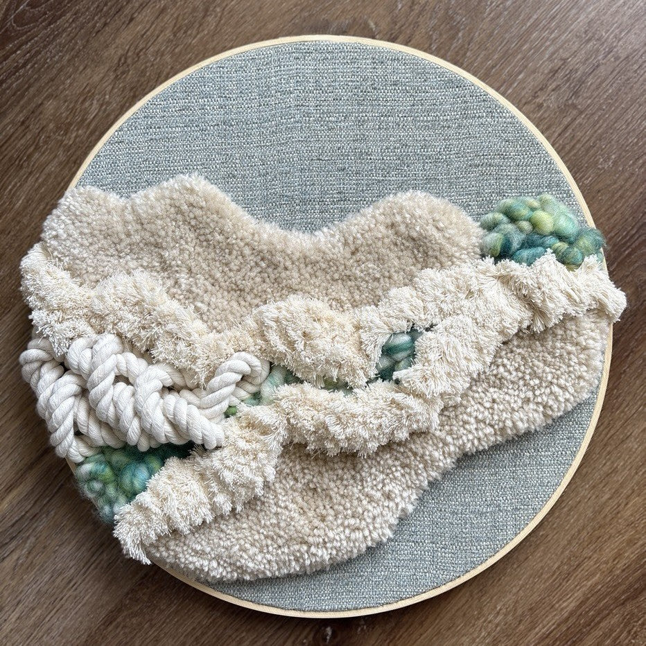 Textured fabric on a wooden surface with a circular blue mat underneath