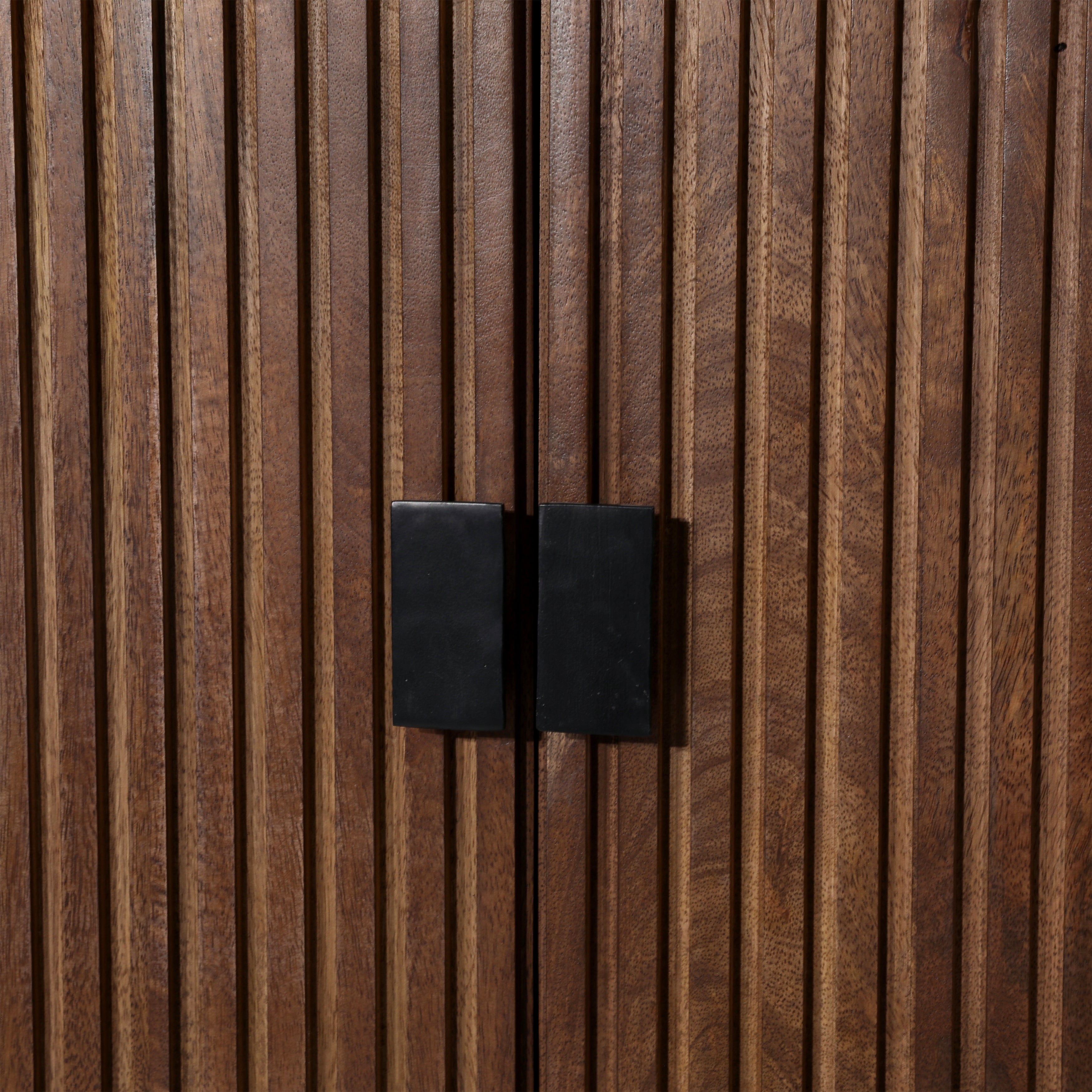 Close-up of a wooden door with black rectangular handles
