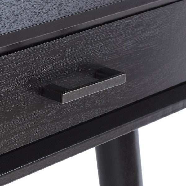 Close-up of a black drawer with handle on a wooden surface