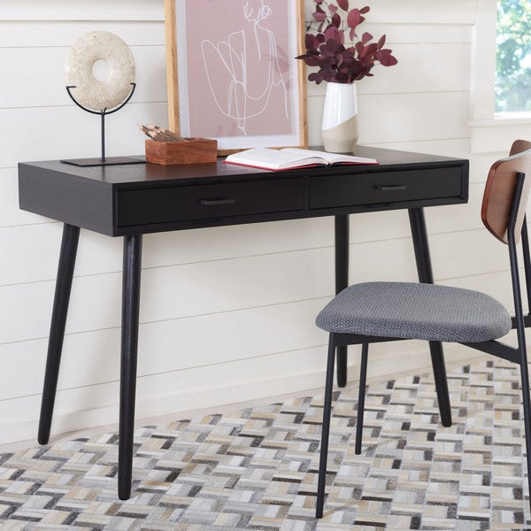 Black desk with a chair in a room with decorative elements
