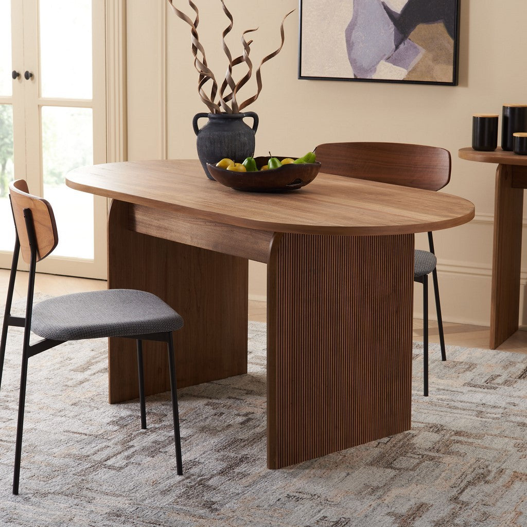 Wooden dining table with chairs in a room with a painting on the wall.