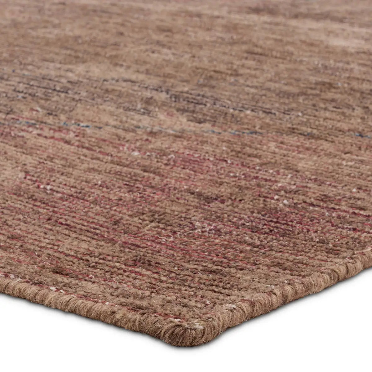 Close-up of a textured brown rug with red accents on a white background