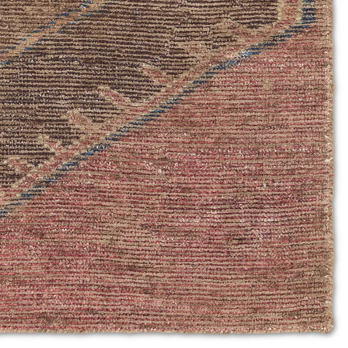 Close-up of a textured brown and red rug with a subtle pattern.