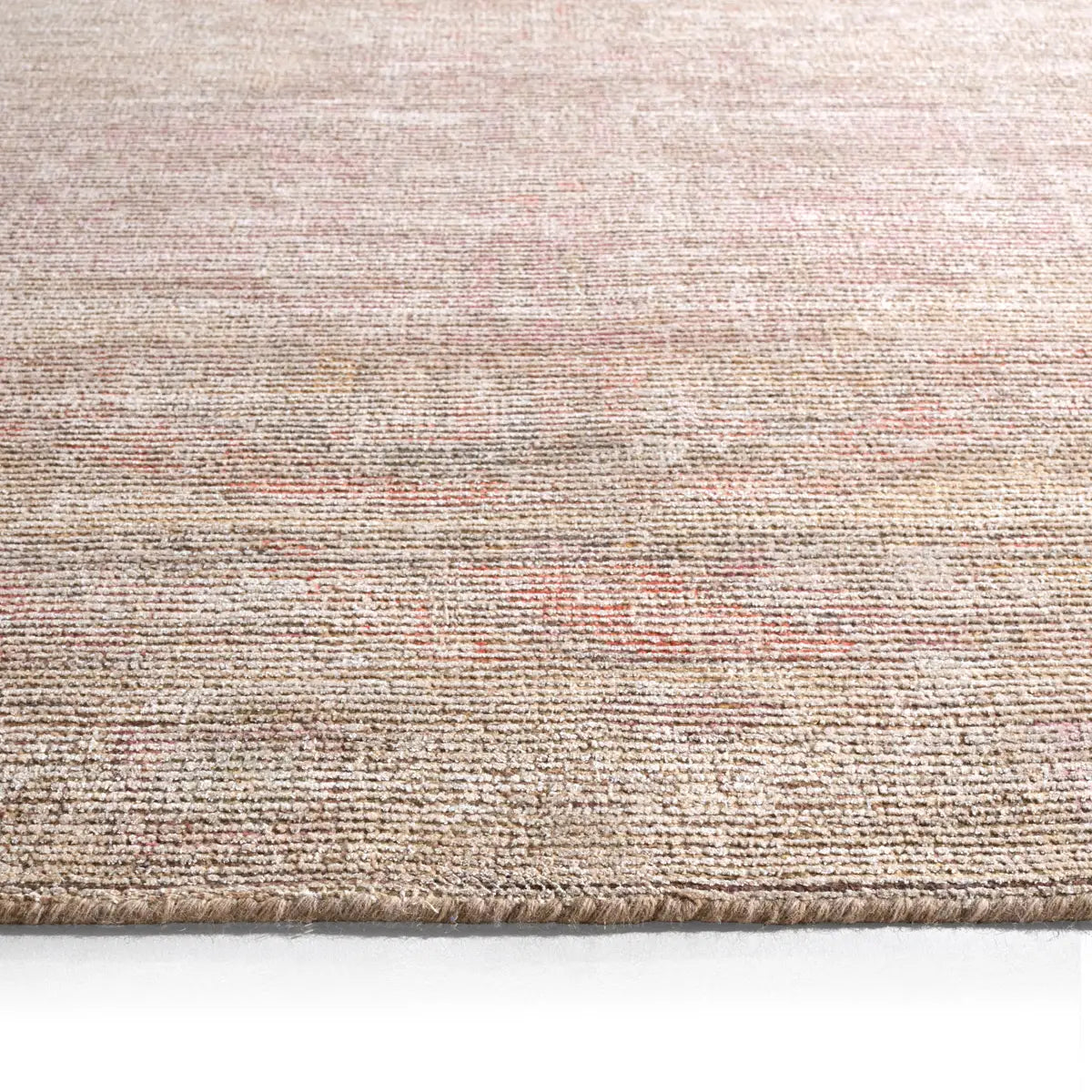 Close-up of a textured beige rug on a white background