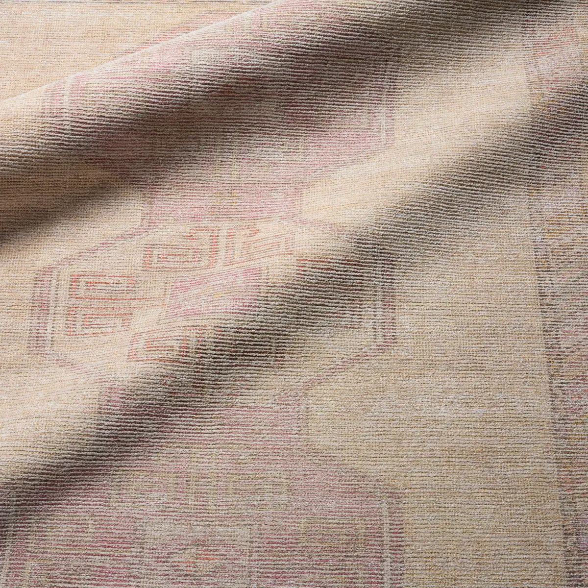 Close-up of textured fabric with a brand logo on a beige background